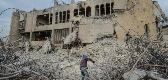 ISIS news: An Iraqi climbs up the rubble of the destroyed seven-storey Chadirji Building, designed by celebrated Iraqi architect Rifat Chadirji in the 1960s, on January 13, 2019, in the city of Mosul.