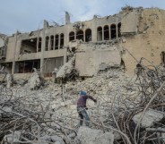 ISIS news: An Iraqi climbs up the rubble of the destroyed seven-storey Chadirji Building, designed by celebrated Iraqi architect Rifat Chadirji in the 1960s, on January 13, 2019, in the city of Mosul.