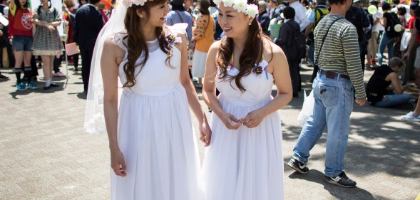 A Japanese same-sex couple in wedding attire takes part in the Tokyo Rainbow Pride Parade on May 6, 2018 in Tokyo, Japan