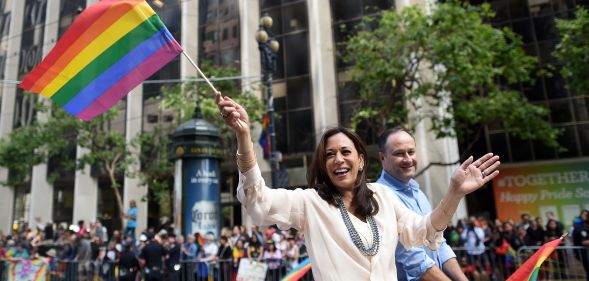 Kamala Harris waves a rainbow flag while participating in the San Francisco Pride parade in San Francisco, California on Sunday, June, 26 2016