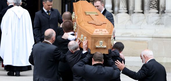 Pallbearers carry the coffin of journalist Lyra McKee