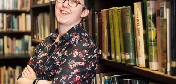 Lyra McKee posing in a library