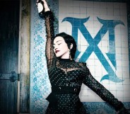 Madonna as Madame X, standing against a wall
