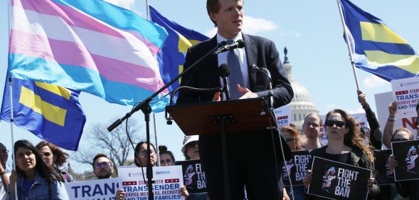 Joe Kennedy at a rally with the White House just behind