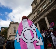 Photo of person adorned in trans flag crime england wales