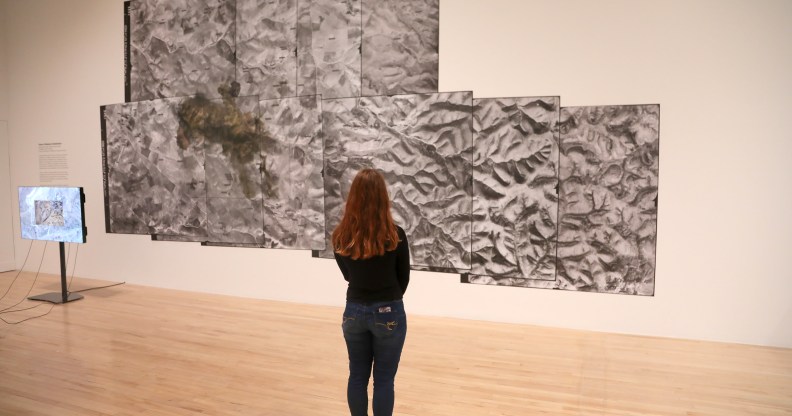 A woman views a video piece by artist Forensic Architecture during the Turner Prize 2018.