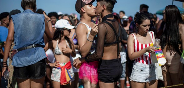 A couple of revellers exchange gay kisses during the Gay Pride parade at Copacabana beach in Rio de Janeiro, Brazil on September 30, 2018
