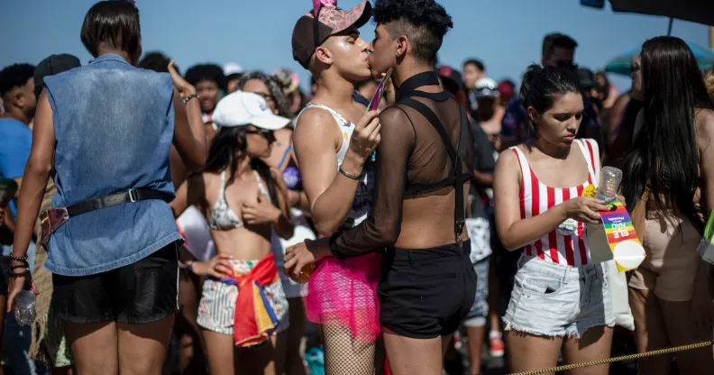 A couple of revellers exchange gay kisses during the Gay Pride parade at Copacabana beach in Rio de Janeiro, Brazil on September 30, 2018