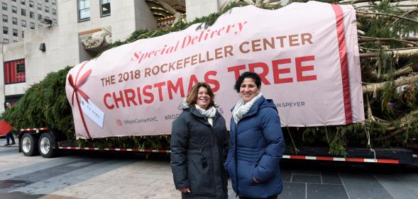 Lesbian couple Shirley Figueroa and Lissette Gutierrez pose with the Rockefeller Center tree they donated.