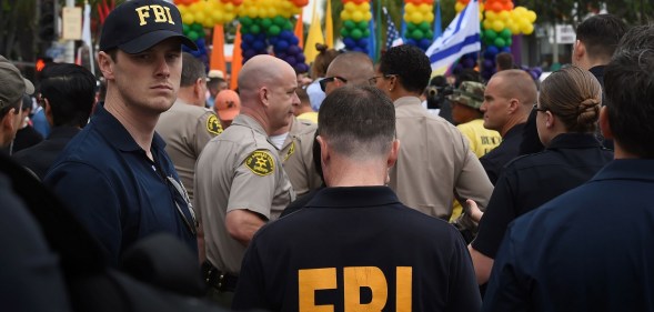 FBI agents keep watch during the 2016 Gay Pride Parade in West Hollywood, California on June 12, 2016.