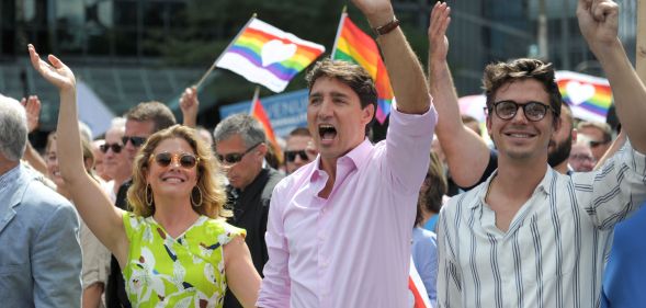 Prime Minister Justin Trudeau, who has approved the design of the new $1 coin, marches at pride.