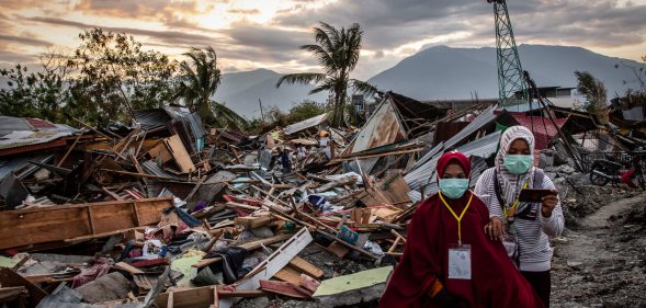 PALU, INDONESIA - OCTOBER 05: People walk along a damaged area which was hit by liquefaction in Petobo village following the earthquake on October 5, 2018 in Palu, Central Sulawesi, Indonesia. The death toll from last weeks earthquake and tsunami has risen to at least 1,558 but widely expected to rise as officials said on Friday the number of victims of the liquefaction could be up to a thousand. Power had returned to parts of the city and fuel shipments have begun to flow back but some affected towns remain inaccessible with the infrastructure badly damaged. A tsunami triggered by a magnitude 7.5 earthquake slammed into Indonesia's coastline on the island of Sulawesi which destroyed or damaged over 70,000 homes as tensions remain high with desperate survivors trying to secure basics like clean water and fuel for generators. (Photo by Ulet Ifansasti/Getty Images)