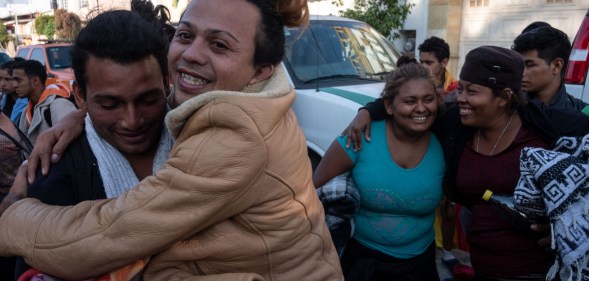 LGBT asylum seekers celebrate their arrival at the US-Mexico border.