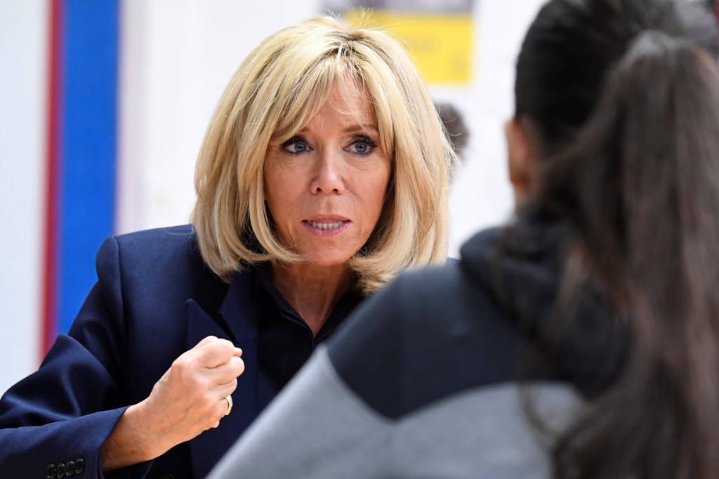 French President's wife Brigitte Macron gestures as she speaks to children during a visit to raise awareness about bullying in Clamart, near Paris, on November 15, 2018.