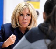 French President's wife Brigitte Macron gestures as she speaks to children during a visit to raise awareness about bullying in Clamart, near Paris, on November 15, 2018.