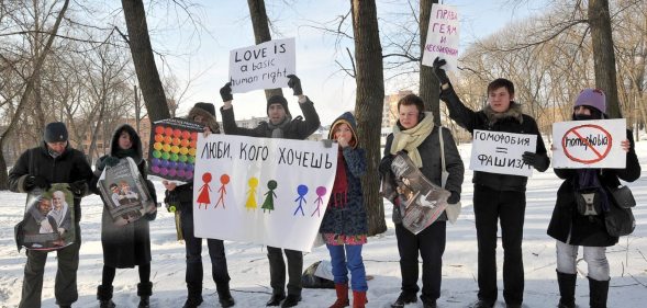 Gay-rights activists hold placards on February 14, 2011 during a rally against homophobia in Minsk. Gay rights activists said they held their first authorized action in Minsk. AFP PHOTO / VIKTOR DRACHEV (Photo credit should read VIKTOR DRACHEV/AFP/Getty Images)