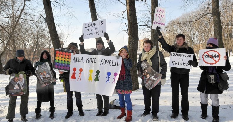 Gay-rights activists hold placards on February 14, 2011 during a rally against homophobia in Minsk. Gay rights activists said they held their first authorized action in Minsk. AFP PHOTO / VIKTOR DRACHEV (Photo credit should read VIKTOR DRACHEV/AFP/Getty Images)