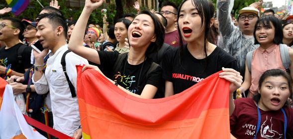 Supporters of same-sex marriage celebrate outside the parliament in Taipei on May 17, 2019. - Taiwan's parliament legalised same-sex marriage on May 17, 2019, in a landmark first for Asia as the government survived a last-minute attempt by conservatives to pass watered-down legislation.
