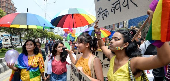 Members of Nepal's LGBT+ community hold placards as they take part in a Pride Parade in Kathmandu on June 29, 2019