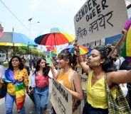 Members of Nepal's LGBT+ community hold placards as they take part in a Pride Parade in Kathmandu on June 29, 2019