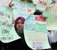 Protesters raise placards during a protest outside a corridor Mosque in Shah Alam near Kuala Lumpur on November 4, 2011. The demonstration was to urge the goverment to give recognition to the lesbian, gay, bisexual and transgender (LGBT) community. AFP PHOTO/MOHD RASFAN (Photo credit should read MOHD RASFAN/AFP/Getty Images)