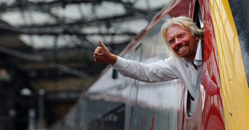 British entrepreneur Sir Richard Branson leans out of the window of the driver's cab on board a Virgin Pendolino train at Lime Street Station in Liverpool, north-west England, on March 13, 2012, as he prepares to launch a Global Entrepreneurship Congress. The event aims to be the largest gathering of start-up champions from around the world. AFP PHOTO/PAUL ELLIS (Photo credit should read PAUL ELLIS/AFP/Getty Images)