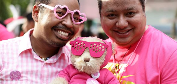 SINGAPORE - JUNE 30: Participants dress in various shades of pink pose for a photo during the 'Night Pink Dot' event arrange to increase awareness and understanding of the lesbian, gay, bisexual and transgender community in Singapore at Hong Lim Park on June 30, 2012 in Singapore. The event is the fourth annual gathering held in support of the freedom to love. (Photo by Suhaimi Abdullah/Getty Images)