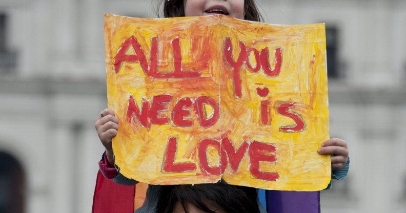 Man with daughter on shoulders protest for LGBT right