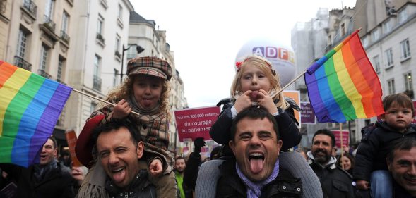 PARIS, FRANCE - DECEMBER 16: People demonstrate for the legalisation of gay marriage and parenting on December 16, 2012 in Paris, France. Demonstrations have shown a deep division in French society over the marriage equality bill expected to be passed in early 2013. The bill would not only legalize same-sex marriage but would also allow gay couples to adopt, which is seen as the most controversial issue. French President Francois Hollande, who has supported the legislation, is facing criticism from anti-gay and religious groups, while gay rights groups have warned of inadequacies within the bill. (Photo by Antoine Antoniol/Getty Images)