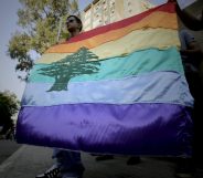 A gay pride flag bearing the cedar tree in the middle of it is carried by human rights activists during an anti-homophobia rally in Beirut on April 30, 2013. Lebanese homosexuals, human rights activists and members from the NGO Helem (the Arabic acronym of "Lebanese Protection for Lesbians, Gays, Bisexuals and Transgenders") rallied to condemn the arrest on the weekend of three gay men and one transgender civilian in the town of Dekwaneh east of Beirut at a nightclub who were allegedly verbally and sexually harassed at the municipality headquarters. AFP PHOTO/JOSEPH EID / AFP PHOTO / Joseph EID (Photo credit should read JOSEPH EID/AFP/Getty Images)