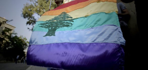 A gay pride flag bearing the cedar tree in the middle of it is carried by human rights activists during an anti-homophobia rally in Beirut on April 30, 2013. Lebanese homosexuals, human rights activists and members from the NGO Helem (the Arabic acronym of "Lebanese Protection for Lesbians, Gays, Bisexuals and Transgenders") rallied to condemn the arrest on the weekend of three gay men and one transgender civilian in the town of Dekwaneh east of Beirut at a nightclub who were allegedly verbally and sexually harassed at the municipality headquarters. AFP PHOTO/JOSEPH EID / AFP PHOTO / Joseph EID (Photo credit should read JOSEPH EID/AFP/Getty Images)