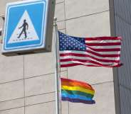 A Pride flag is raised next to the US flag.