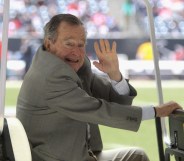 Former U.S. President George H.W. Bush waves during the game between the New England Patriots and the Houston Texans at Reliant Stadium on December 1, 2013 in Houston, Texas.