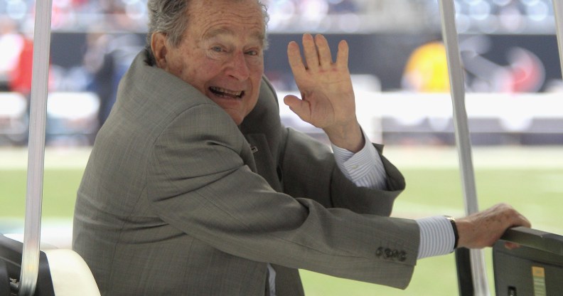 Former U.S. President George H.W. Bush waves during the game between the New England Patriots and the Houston Texans at Reliant Stadium on December 1, 2013 in Houston, Texas.