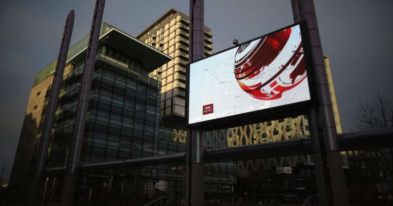 SALFORD, ENGLAND - JANUARY 05: A giant outdoor television screen broadcasts the BBC News at Media City in Salford Quays which is home to the BBC, ITV television studios and also houses many media production companies on January 5, 2015 in Salford, England. The BBC and neighbour ITV Granada with its cobbled street studios of ITV soap opera 'Coronation Street', line the banks of the Manchester Ship Canal.