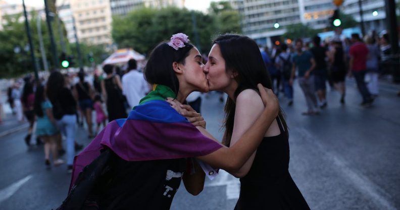 two womn kiss as they take part in the annual Gay Pride parade in Athens, on June 13, 2015. Greece's radical-left government on June 10, 2015, proposed a bill to grant same-sex couples the right to a civil union, two years after the European Court of Human Rights condemned the country's existing legislation as discriminatory. AFP PHOTO / ANGELOS TZORTZINIS (Photo credit should read ANGELOS TZORTZINIS/AFP/Getty Images)