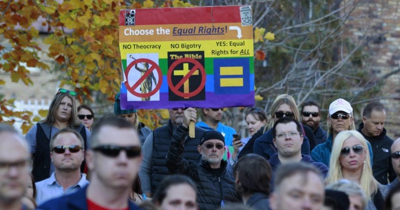 SALT LAKE CITY, UT - NOVEMBER14: A man holds a protest sign in City Creek Park after many submitted their resignations from the Church of Jesus Christ of Latter-Day Saints in response to a recent change in church policy towards married LGBT same sex couples and their children on November 14, 2015 in Salt Lake City, Utah. A little over a week ago the Mormon church made a change in their official handbook of instructions requiring a disciplinary council and possible excommunication for same sex couples and banning the blessing and baptism of their children into the church. (Photo by George Frey/Getty Images)