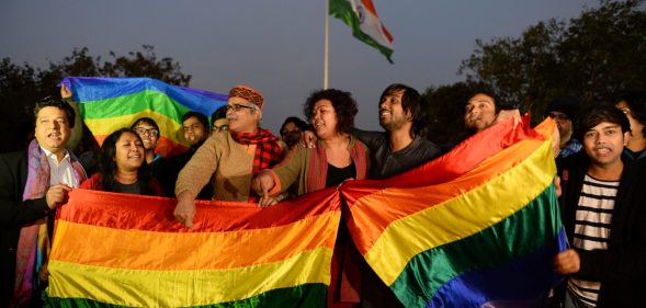 Activists are seen celebrating after India's Supreme Court agreed to lift a ban on same-sex relations.