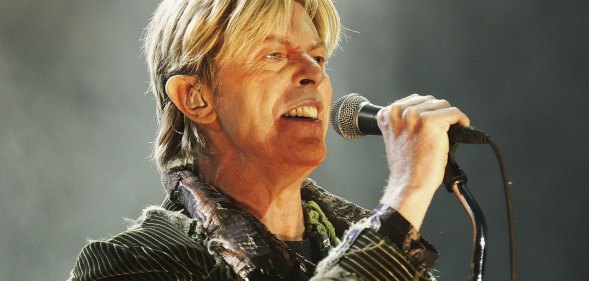 This is an image of the singer David Bowie performing on stage.