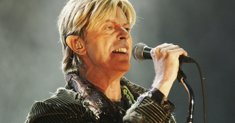 This is an image of the singer David Bowie performing on stage.
