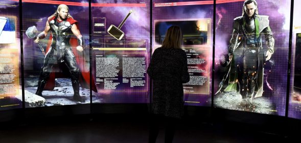 A visitor looks at a display on Marvel Comics superhero "Thor" (L) and character "Loki" at the interactive Marvel Avengers STATION exhibition in the bussines district of La Defense, west of Paris, on April 13, 2016. / AFP / MIGUEL MEDINA / RESTRICTED TO EDITORIAL USE - MANDATORY MENTION OF THE ARTIST UPON PUBLICATION - TO ILLUSTRATE THE EVENT AS SPECIFIED IN THE CAPTION (Photo credit should read MIGUEL MEDINA/AFP/Getty Images)