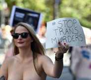 A woman holds up a sign that protests violence against transgender people while participating in the San Francisco Pride parade in San Francisco, California on Sunday, June, 26, 2016. / AFP / Josh Edelson (Photo credit should read JOSH EDELSON/AFP/Getty Images)
