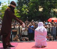 A religious officer canes an Acehnese youth onstage as punishment for dating outside of marriage, which is against sharia law, outside a mosque in Banda Aceh on August 1, 2016. The strictly Muslim province, Aceh has become increasingly conservative in recent years and is the only one in Indonesia implementing Sharia law. / AFP / CHAIDEER MAHYUDDIN (Photo credit should read CHAIDEER MAHYUDDIN/AFP/Getty Images)