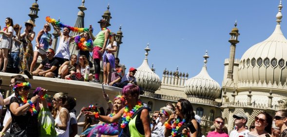 BRIGHTON, ENGLAND - AUGUST 06: People line the streets to watch the Brighton Pride Parade on August 6, 2016 in Brighton, England. (Photo by Tristan Fewings/Getty Images)