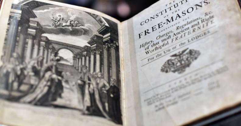 LONDON, ENGLAND - SEPTEMBER 28: A book by James Anderson titled 'The Constitutions of the Free-Masons' dated 1723, is displayed by a member of staff during a press preview for the opening of a gallery titled 'Three Centuries of English Freemasonry' at the Library and Museum of Freemasonry on September 28, 2016 in London, England. To mark Freemasonry's 300th anniversary, a new permanent gallery space is being opened and features items including Winston Churchill's Masonic apron and the Grand Master's Throne. (Photo by Carl Court/Getty Images)