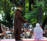 A woman in Aceh is caned 100 times for having sex outside marriage (CHAIDEER MAHYUDDIN/AFP/Getty)