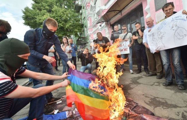 Far-right activists burn the LGBT flag during the official opening of Kyiv Pride 2017