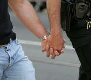 A same-sex couple holding hands, representing the gay couples who met online