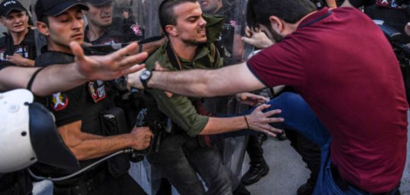 An LGBT activist is kicked by a plain-clothed police officer at banned Istanbul Pride 2017
