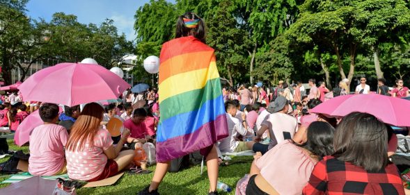 A supporter wrapped in a rainbow flag attends the annual "Pink Dot" event in a public show of support for the LGBT community at Hong Lim Park in Singapore on July 1, 2017. Thousands of Singaporeans took part in the gay-rights rally on July 1. / AFP PHOTO / Roslan RAHMAN (Photo credit should read ROSLAN RAHMAN/AFP/Getty Images)